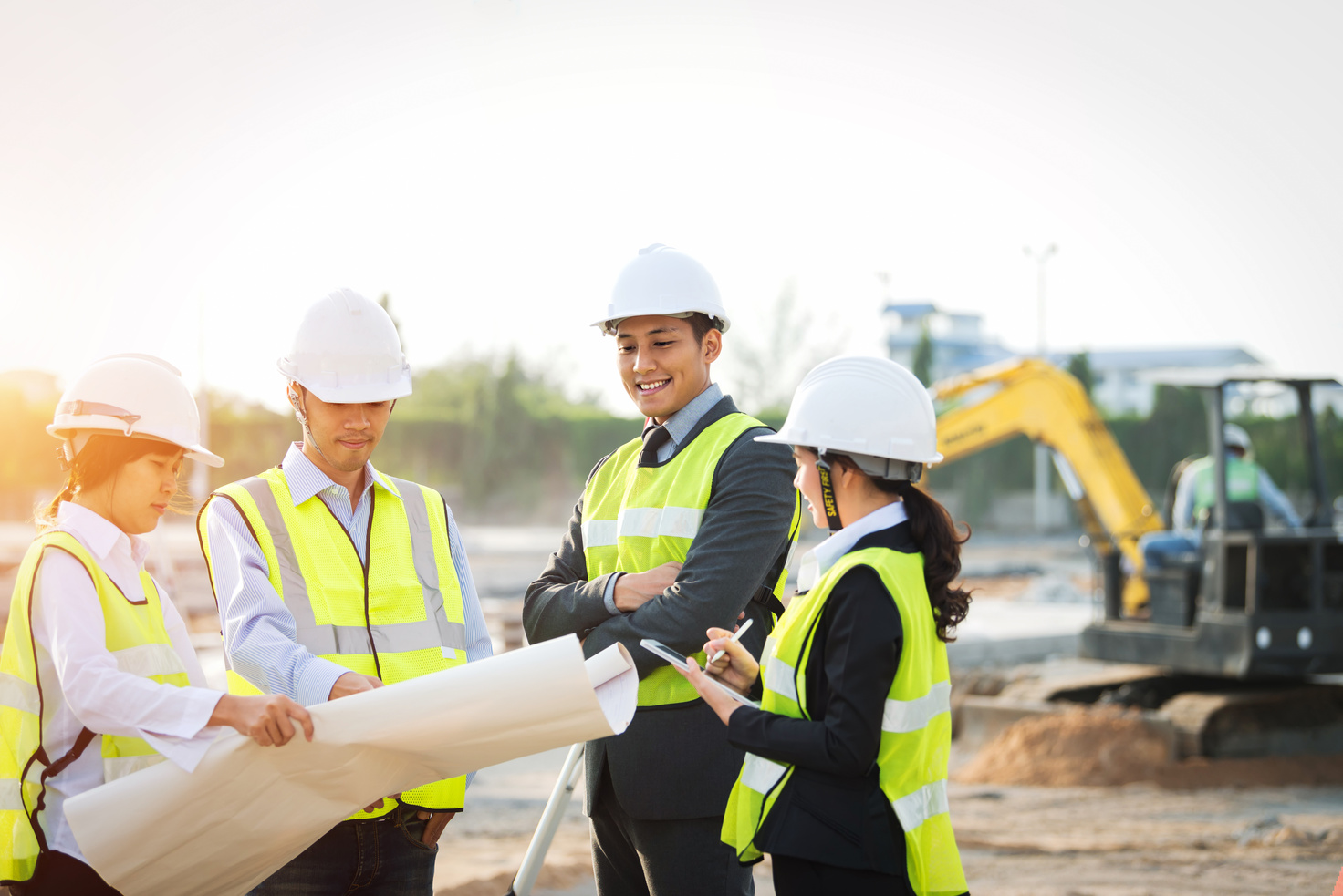 Construction manager architect checking plan on construction site.